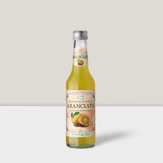 Bottle of Aranciata juice with a label featuring oranges on a white background