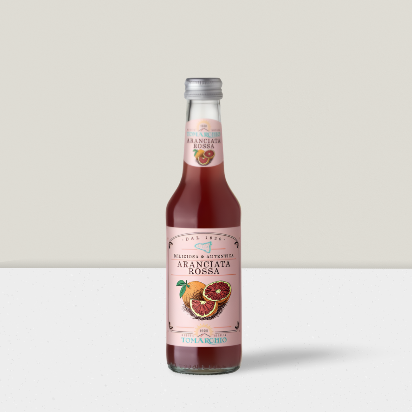 Bottle of Aranciata juice with a pink label on a white background