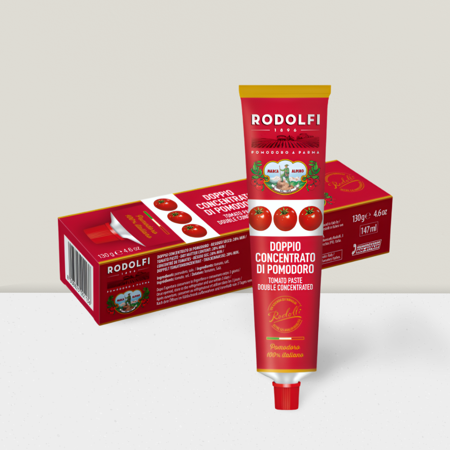 Two tubes of Rodolfi tomato paste with their packaging on a light gray background