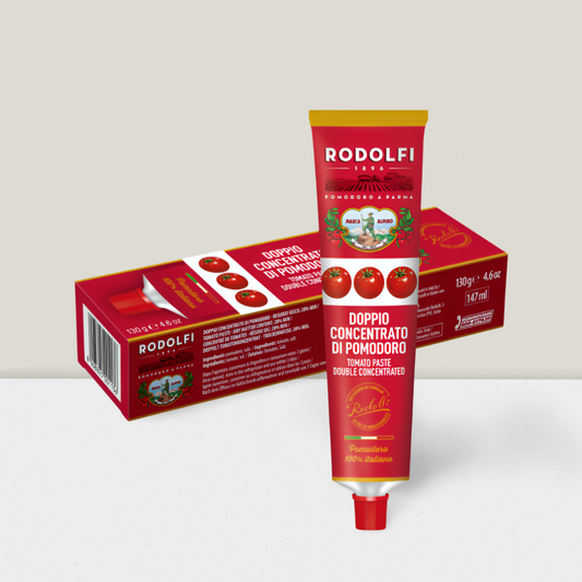Two tubes of Rodolfi tomato paste with their packaging on a light gray background
