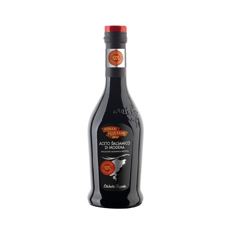 Bottle of Balsamic Vinegar with a red cap on a white background