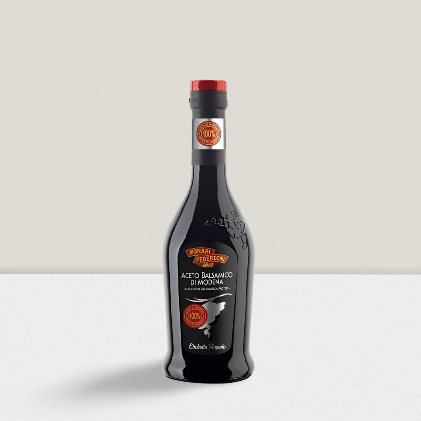 Bottle of balsamic vinegar on a light gray background