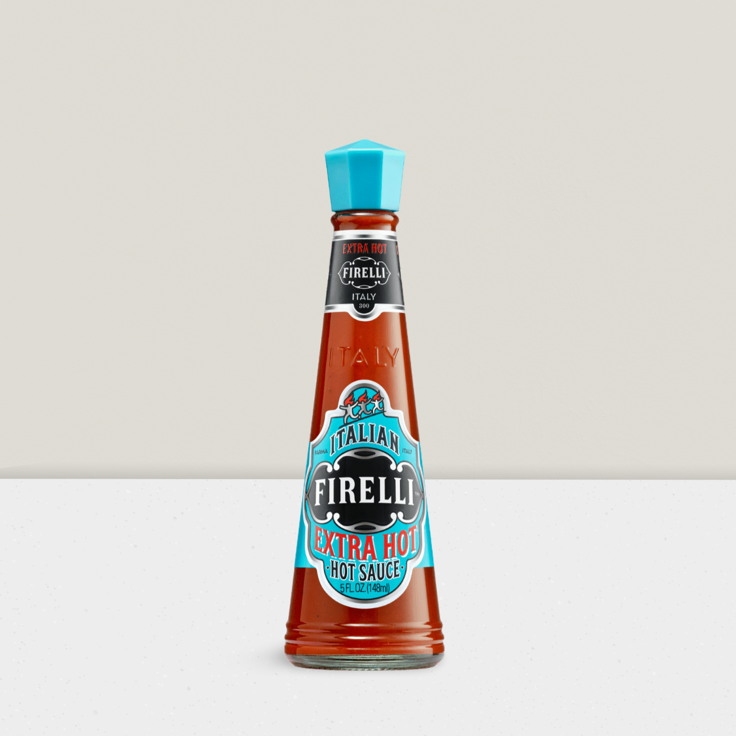 Firelli hot sauce bottle with blue cap on a light gray background