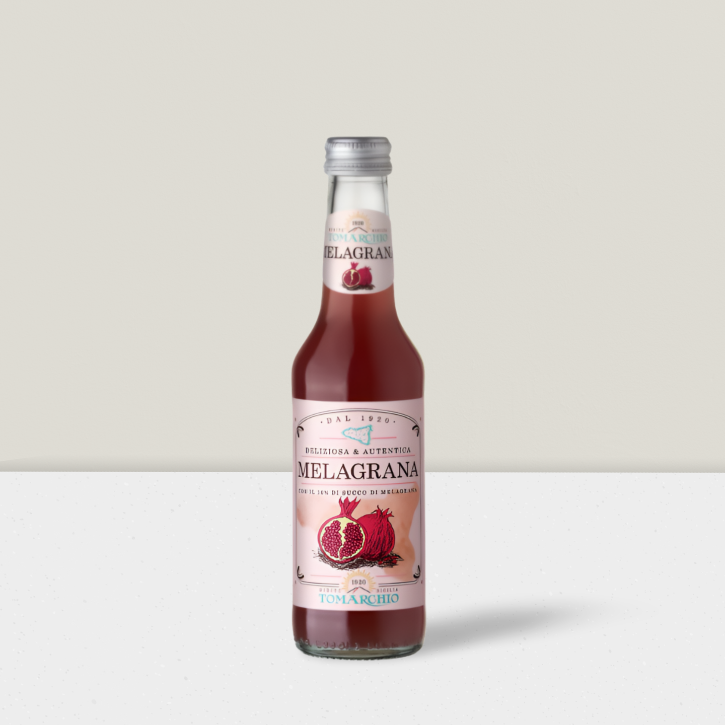 Bottle of Melagrana juice with a white label on a light gray background