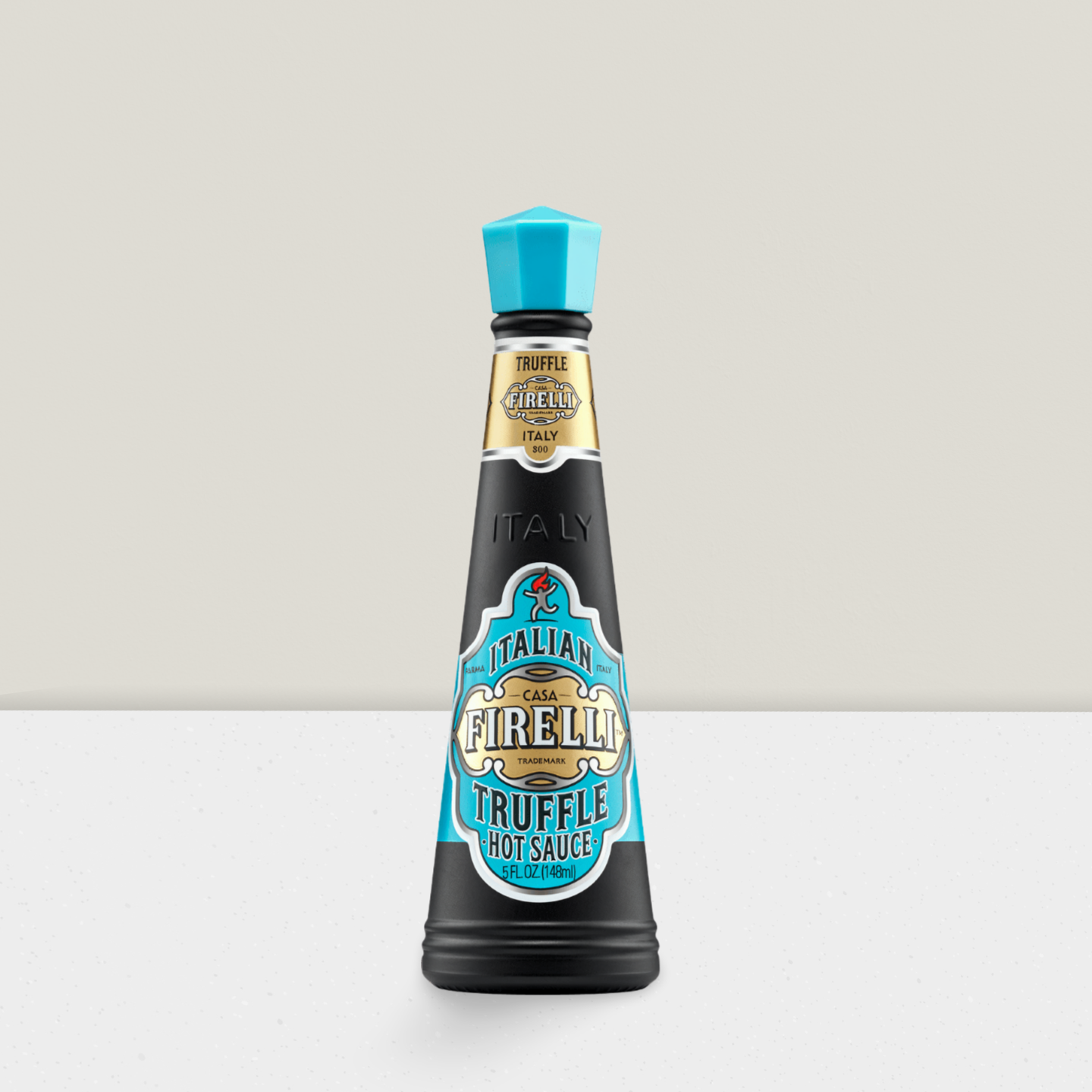 Bottle of Casa Firella truffle hot sauce on a light gray background