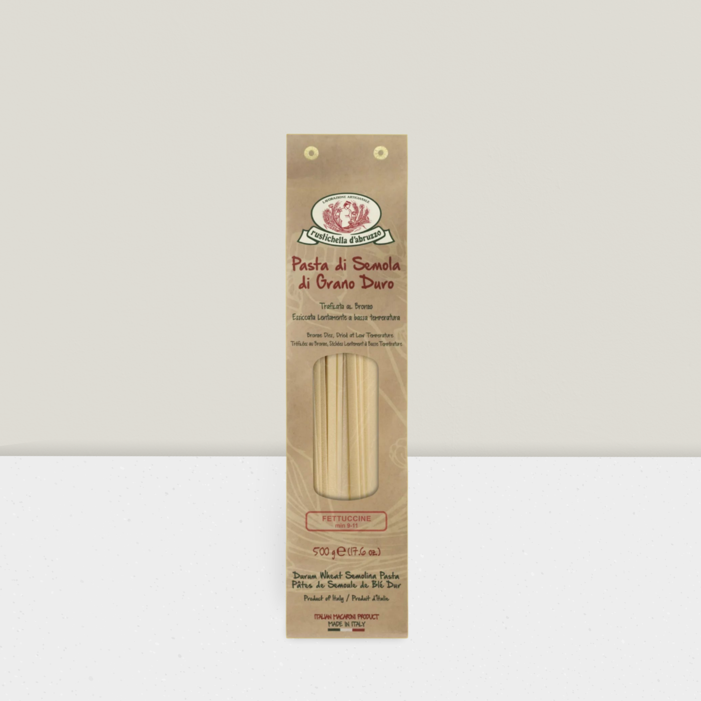 Artisanal pasta in brown paper wrapping bronze drawn fettucine