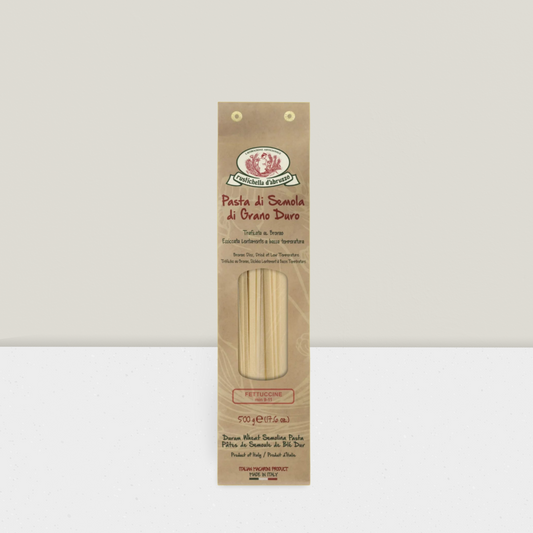 Artisanal pasta in brown paper wrapping bronze drawn fettucine