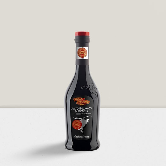 Bottle of balsamic vinegar on a light gray background